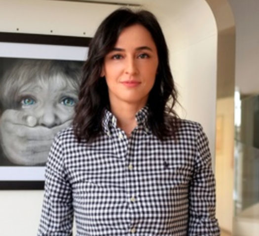 Lena Sugralinova in her studio, in front of one of her drawings